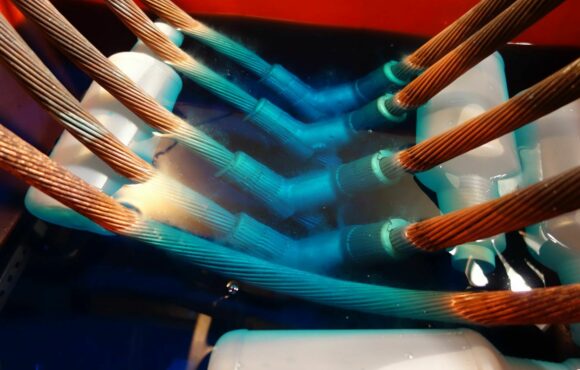 Closeup photograph of connectors submerged in acid bath