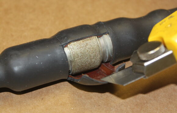 Cable connector cut open to reveal worn interior components