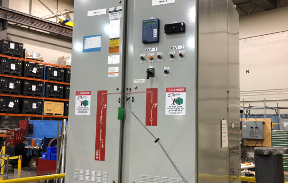 Tall control cabinet mounted onto a seismic table for testing