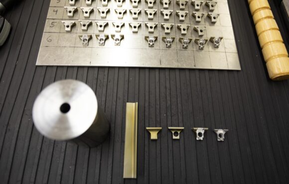 Closeup photograph of various nearly identical machine parts with slight alterations