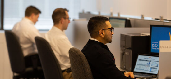 An open office with workers at their stations.