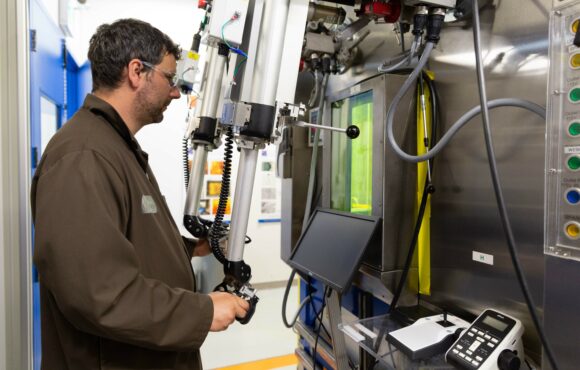 Worker remotely operating a warm cell unit