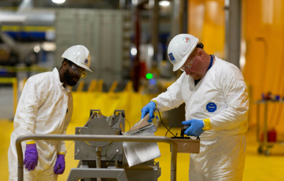 Workers inspecting nuclear equipment