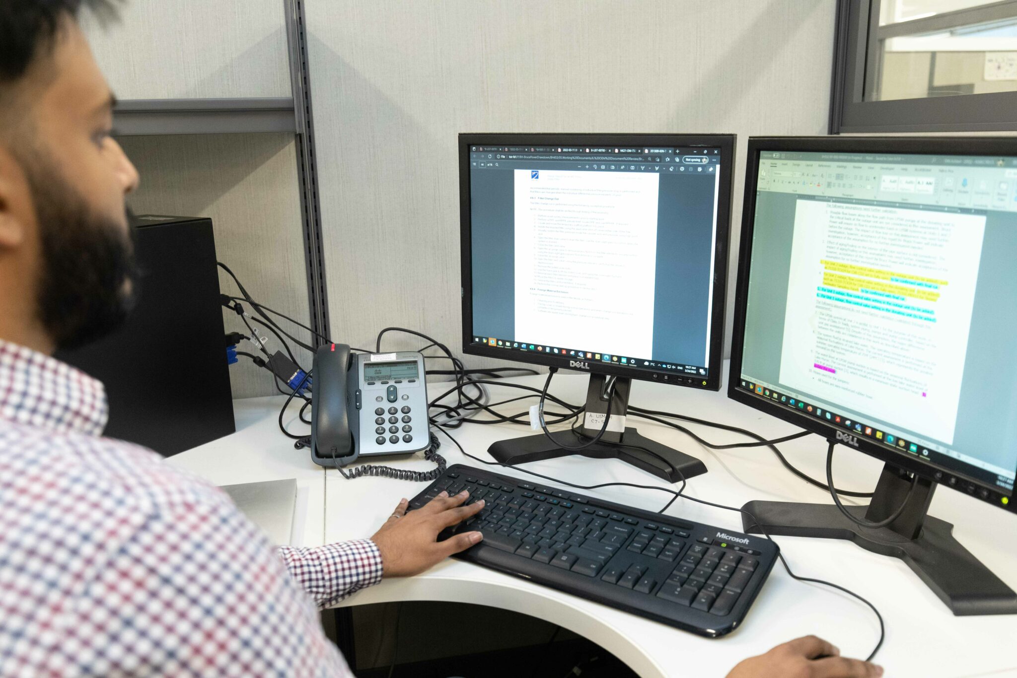 A person looking at data on computer screens