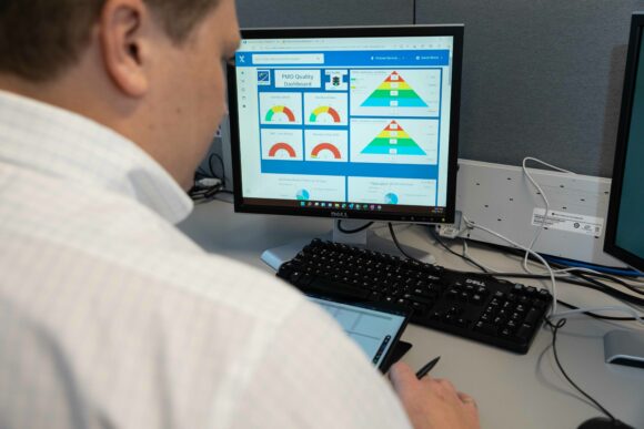 Worker looking at data displayed on a computer screen