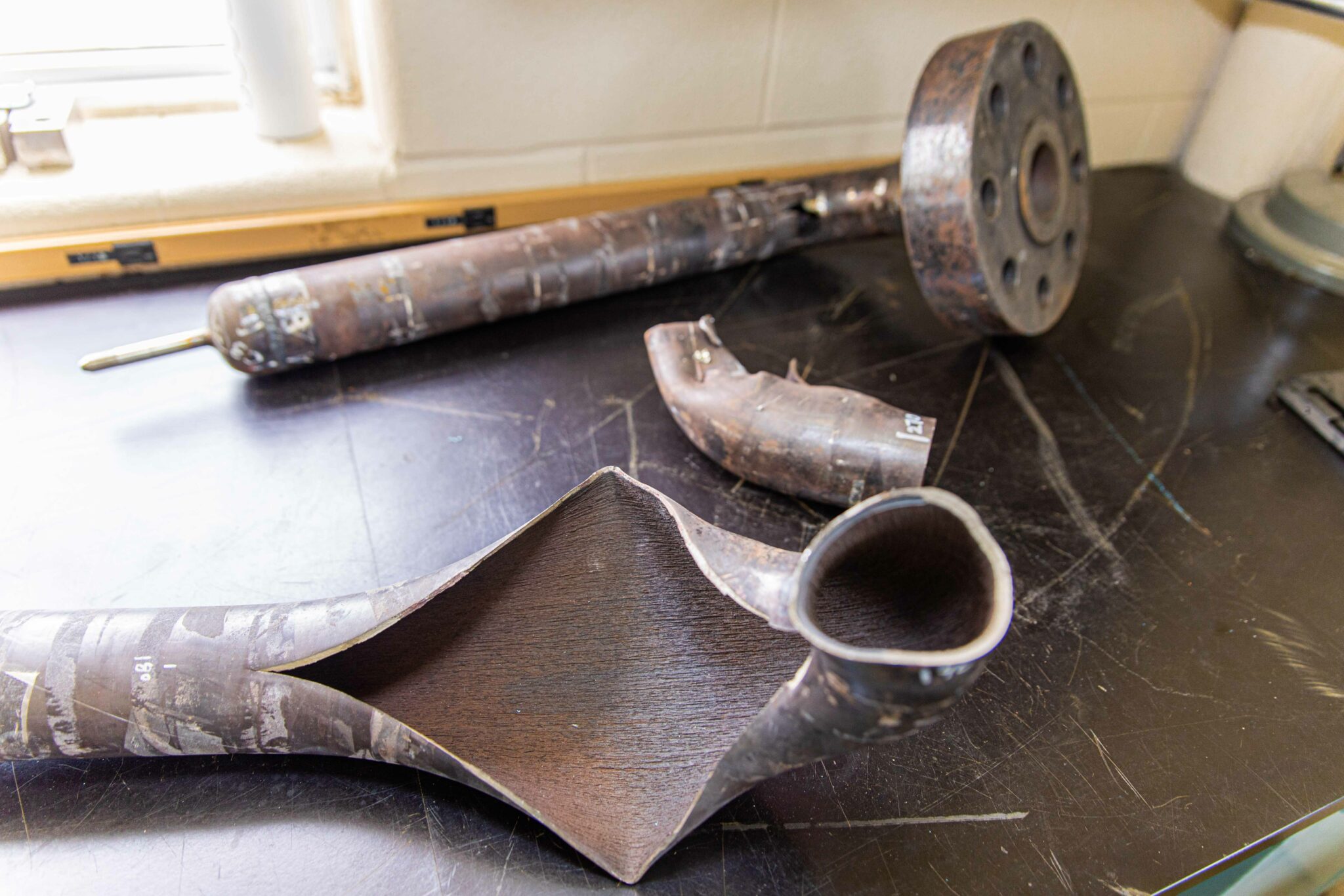 Forensics table featuring worn and burst pipes