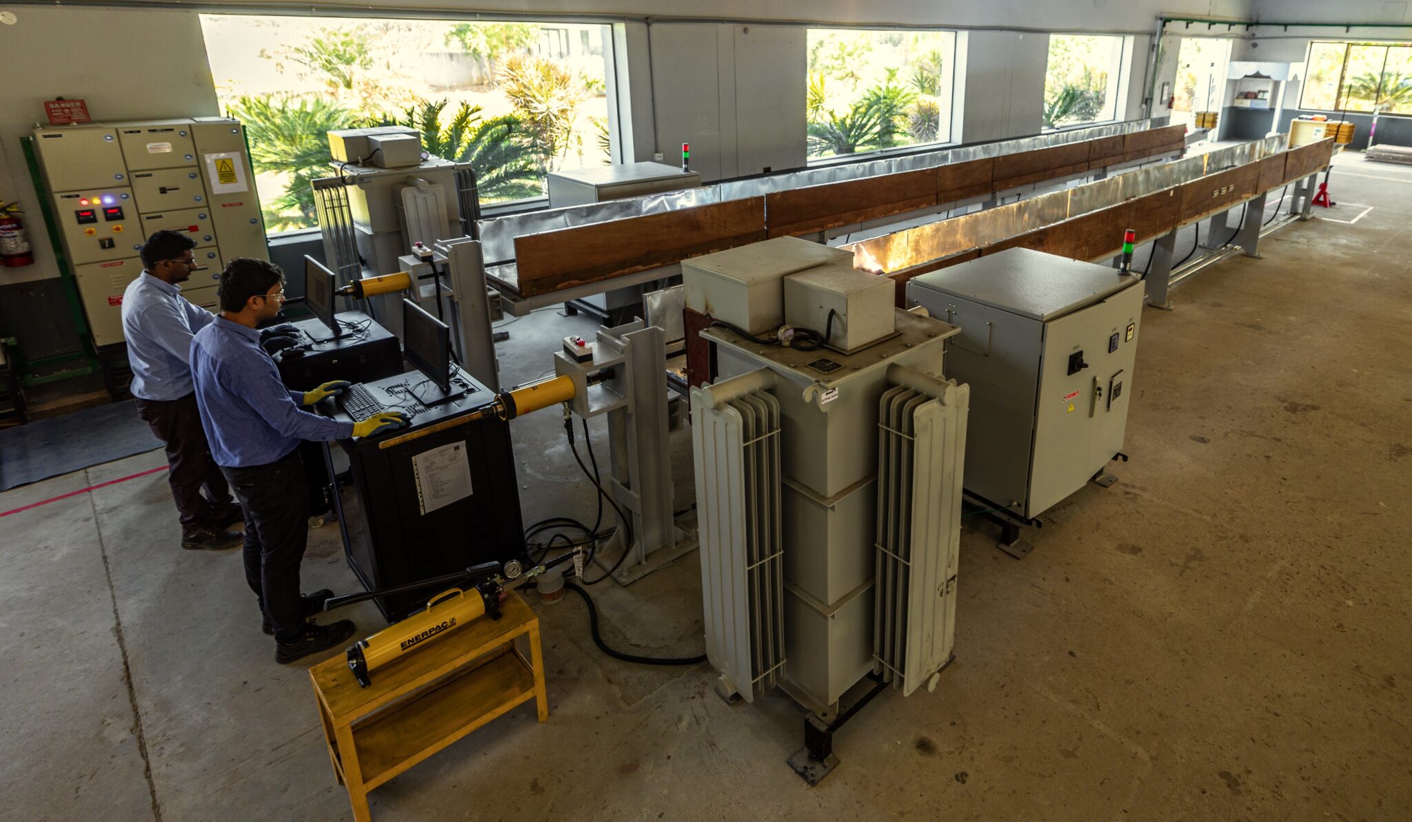 Workers preparing thermo-mechanical test bay for endurance tests